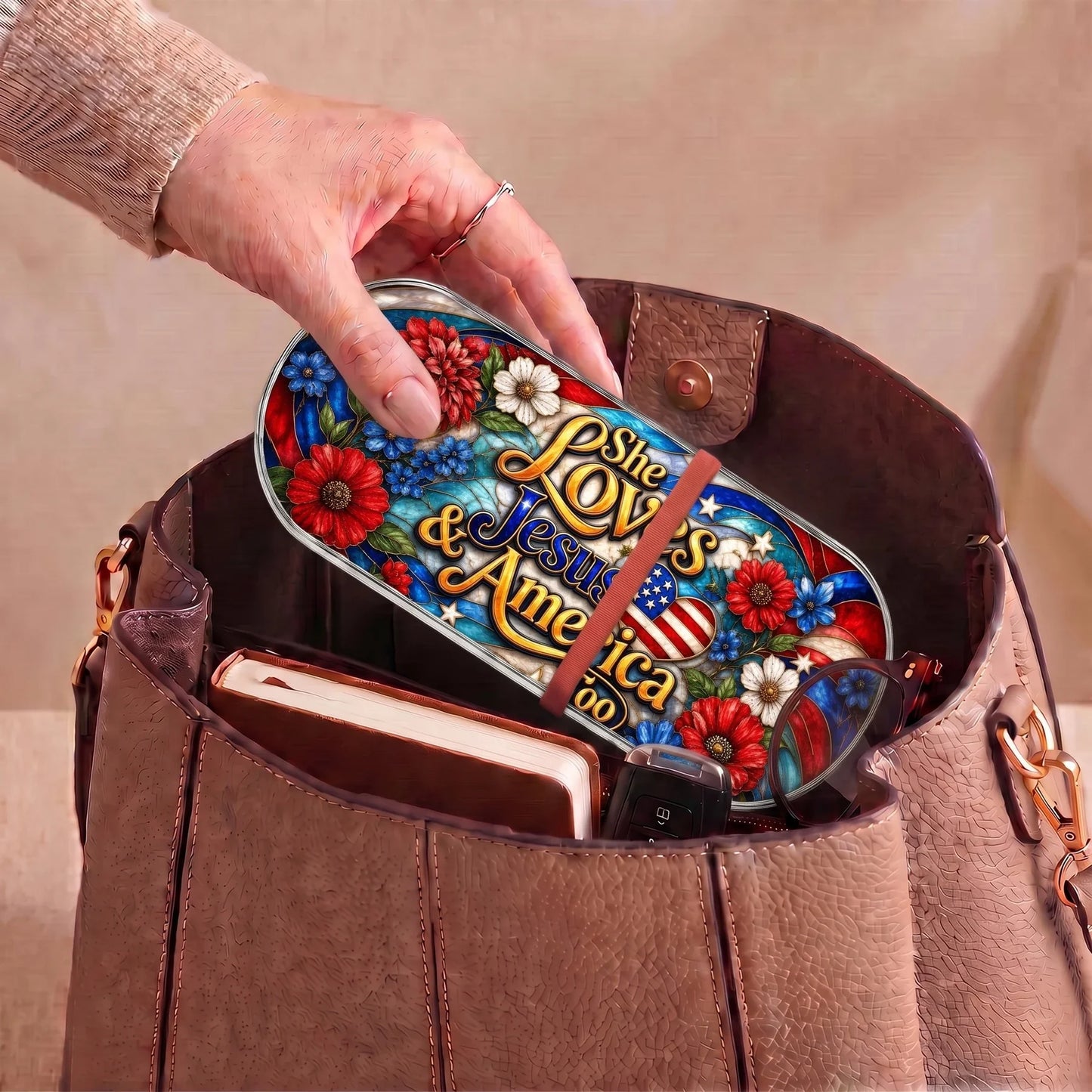 She Loves Jesus and America Too patriotic Pillcase carried inside a handbag with everyday essentials