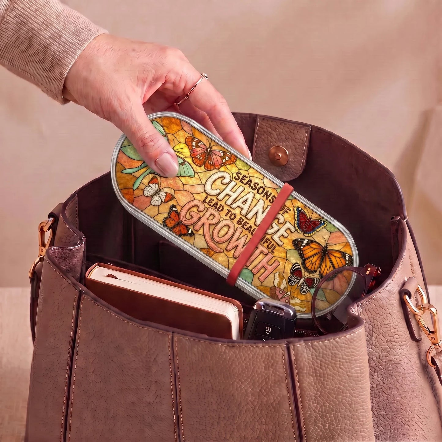 Seasons of Change Lead to Beautiful Growth Pillcase carried inside a handbag with everyday essentials