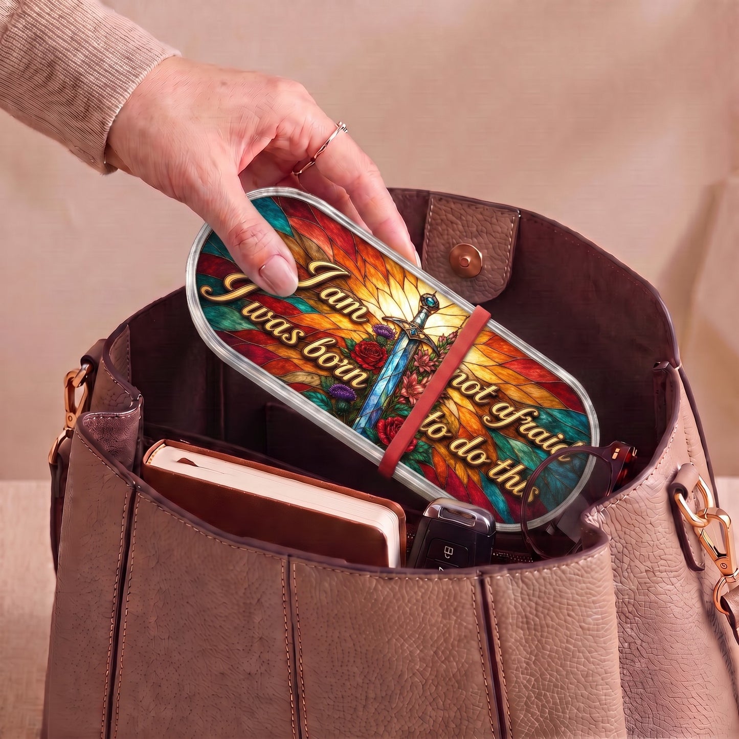 I Am Not Afraid, I Was Born to Do This Pillcase carried inside a handbag with everyday essentials