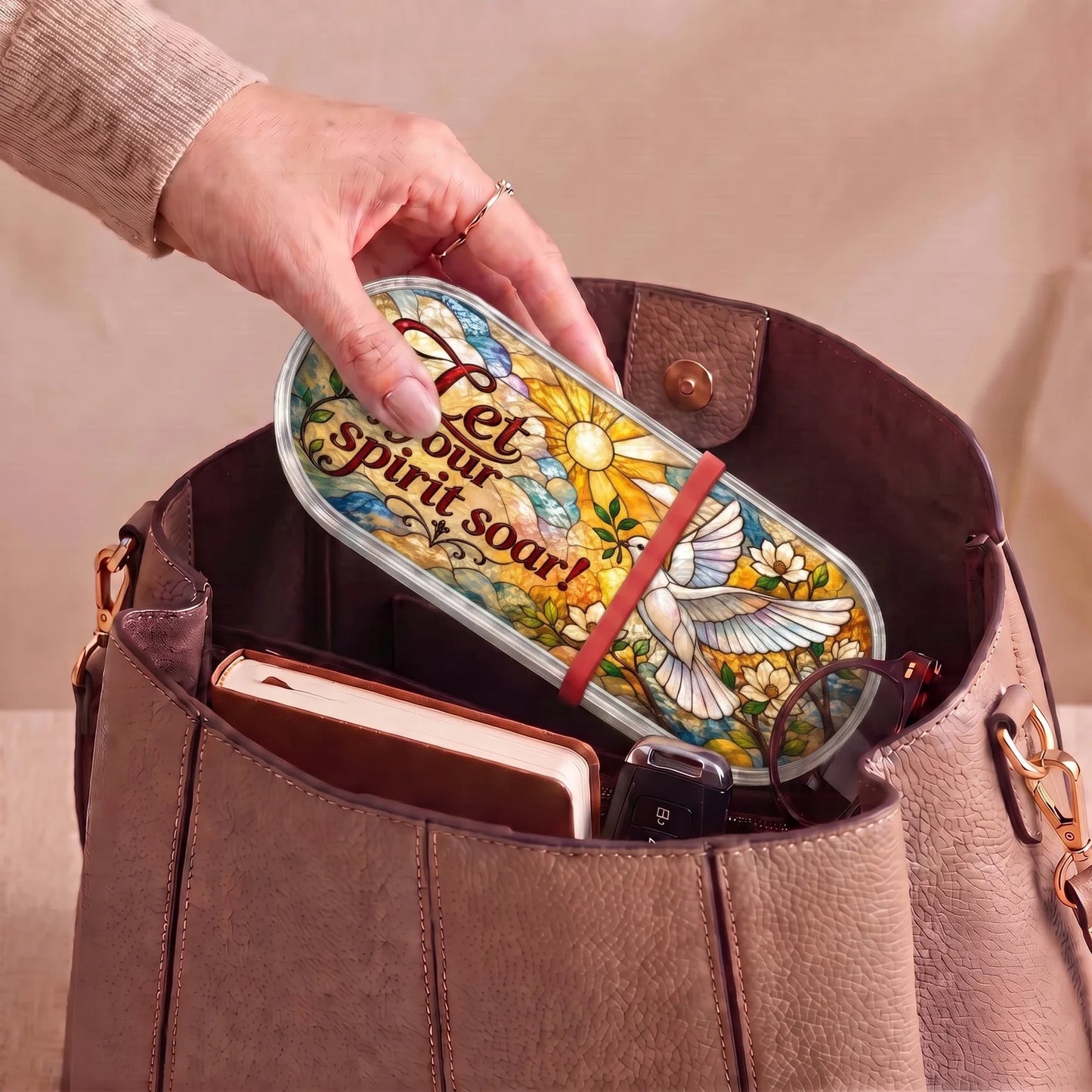 Let Your Spirit Soar dove Pillcase carried inside a handbag with everyday essentials