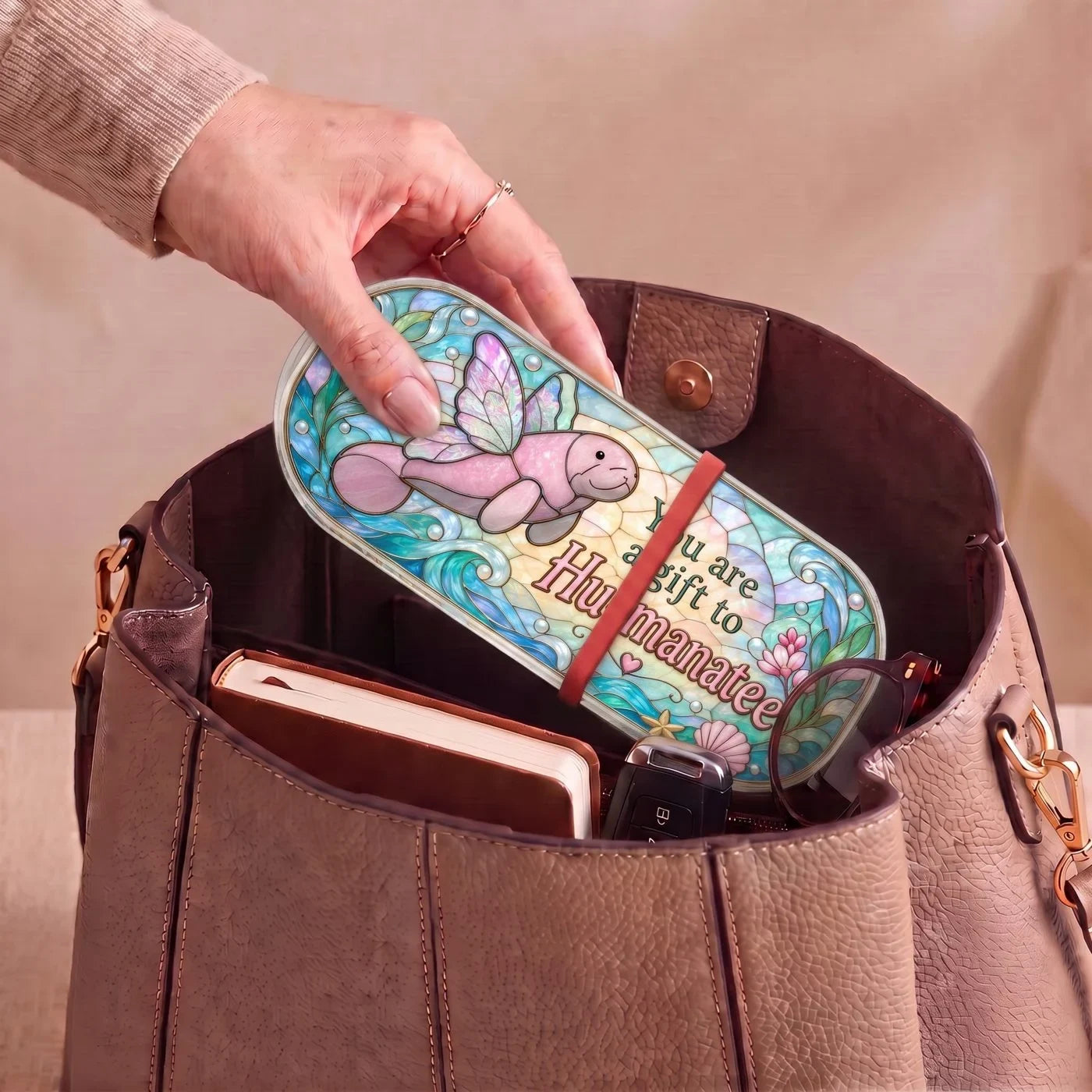 "You Are a Gift to Hu-manatee — Winged Manatee Stained Glass" Pill Case — You Are a Gift to Hu-manatee Pill Case carried inside a handbag