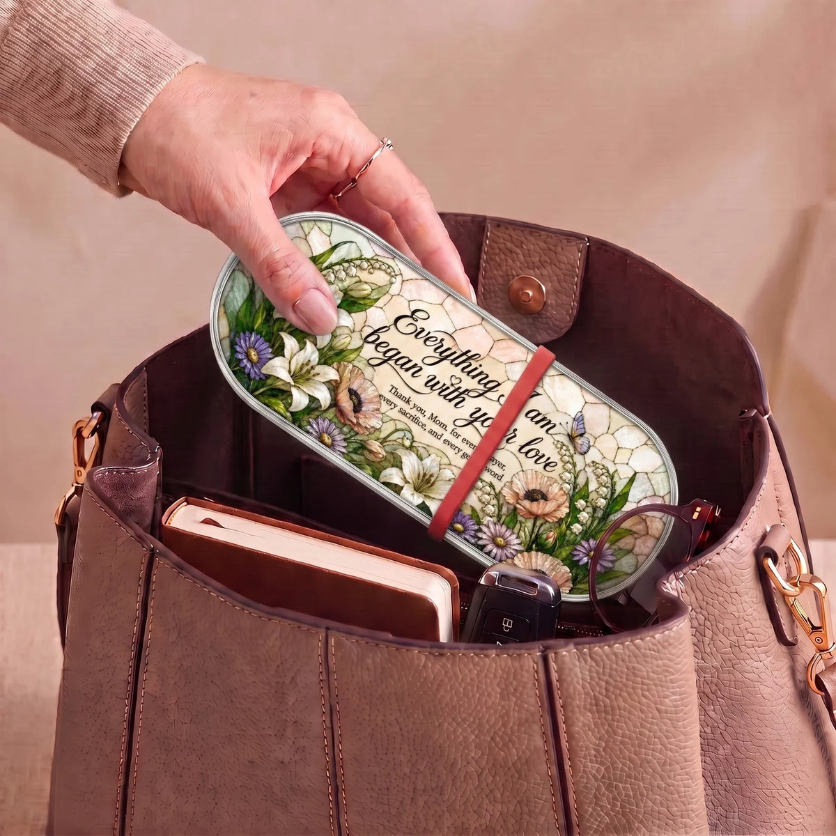 Everything I Am Began with Your Love floral Pillcase carried inside a handbag with everyday essentials