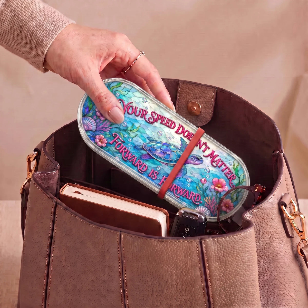 Sea turtle stained-glass Pillcase carried inside a handbag with everyday essentials