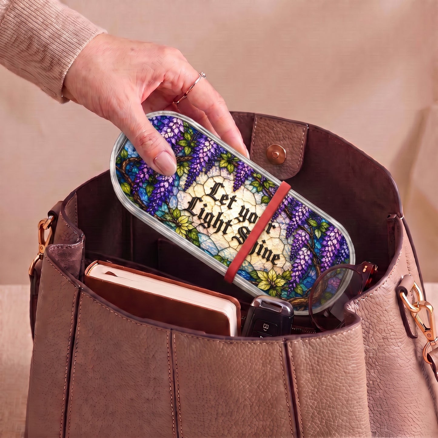 Let Your Light Shine wisteria Pillcase carried inside a handbag with everyday essentials