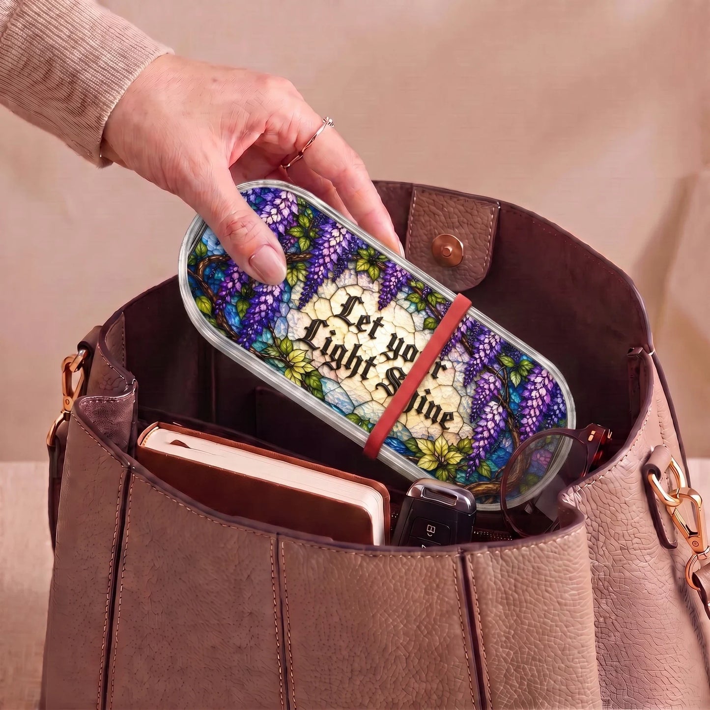 Let Your Light Shine wisteria Pillcase carried inside a handbag with everyday essentials