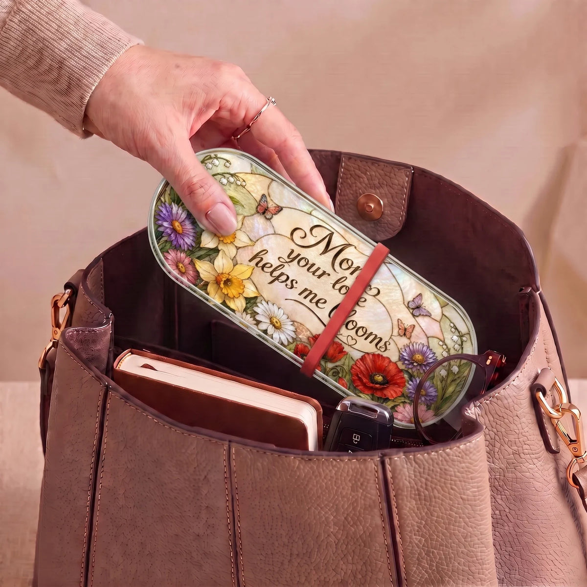 Mom Your Love Helps Me Bloom floral Pillcase carried inside a handbag with everyday essentials