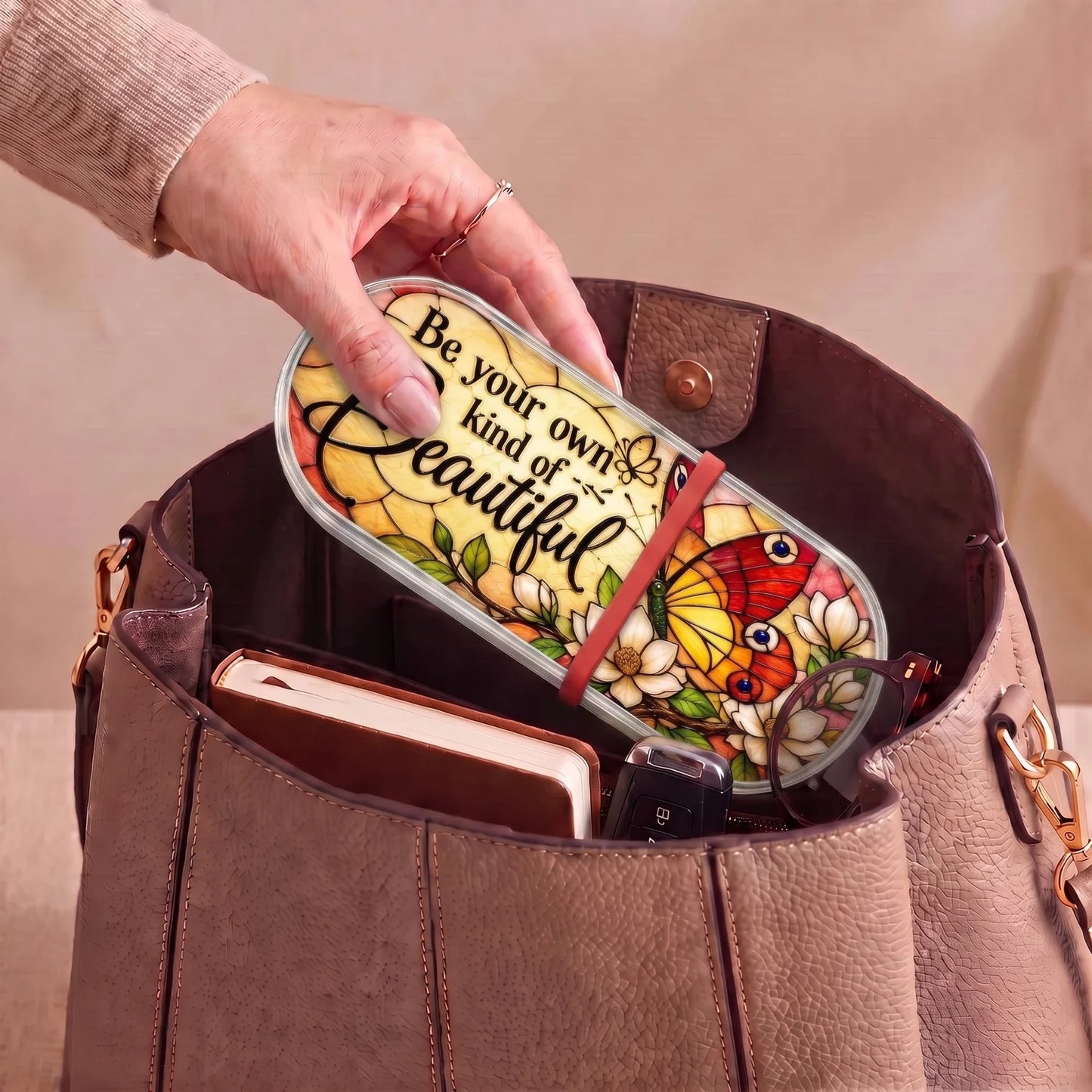 Be Your Own Kind of Beautiful butterfly Pillcase carried inside a handbag with everyday essentials