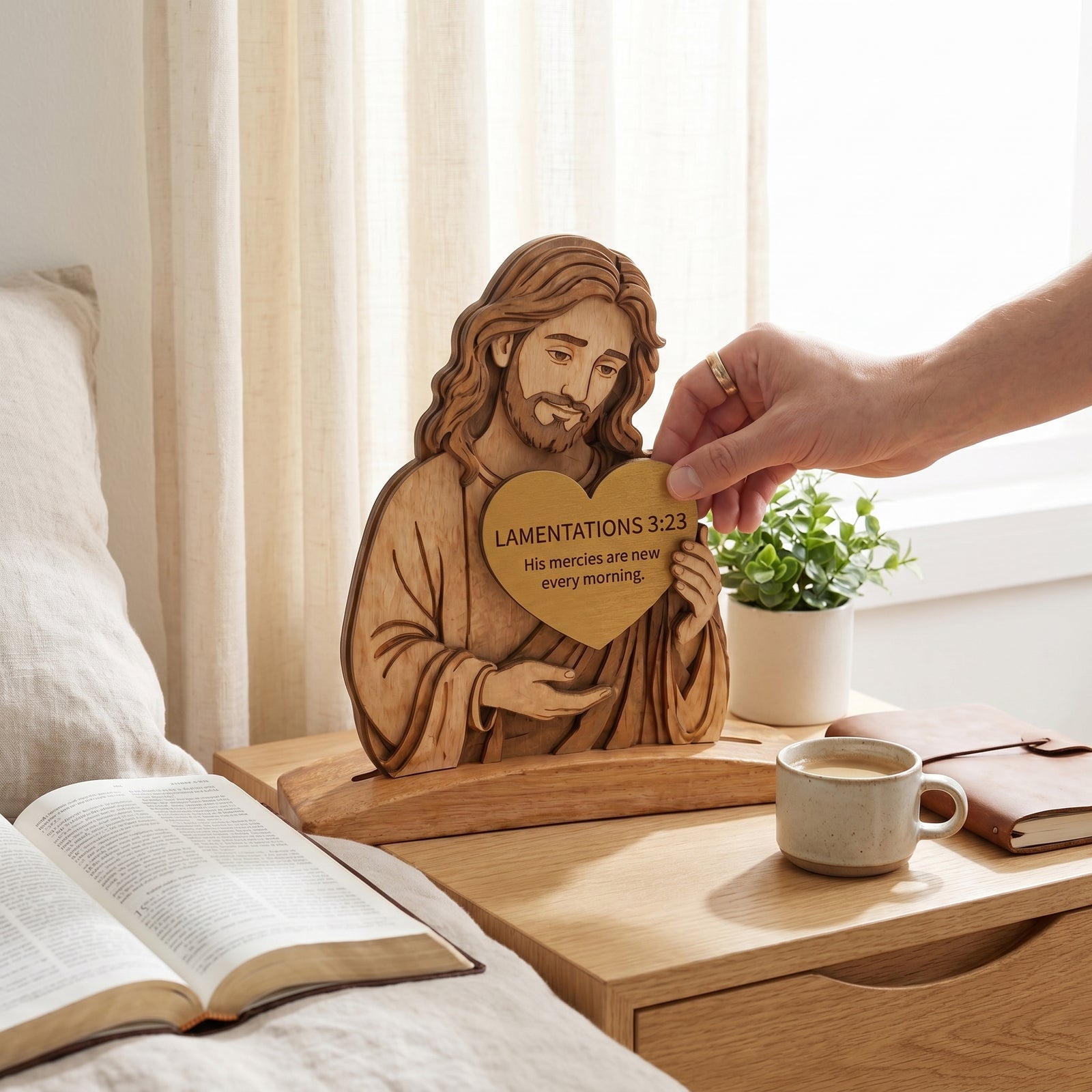 Warm nightstand with Bible, lamp, flowers, and Jesus decor near the bed