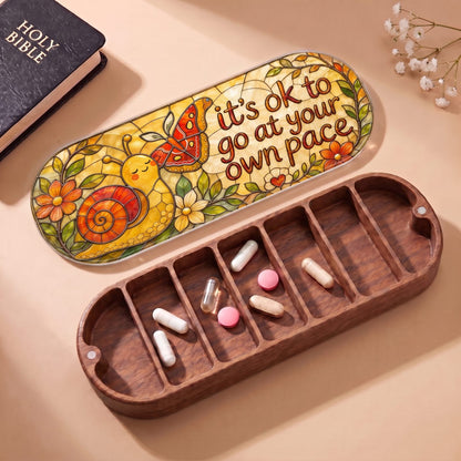 "It’s OK to Go at Your Own Pace — Snail & Butterfly Stained Glass" Pill Case — open Pill Case with Holy Bible, flowers, and assorted pills