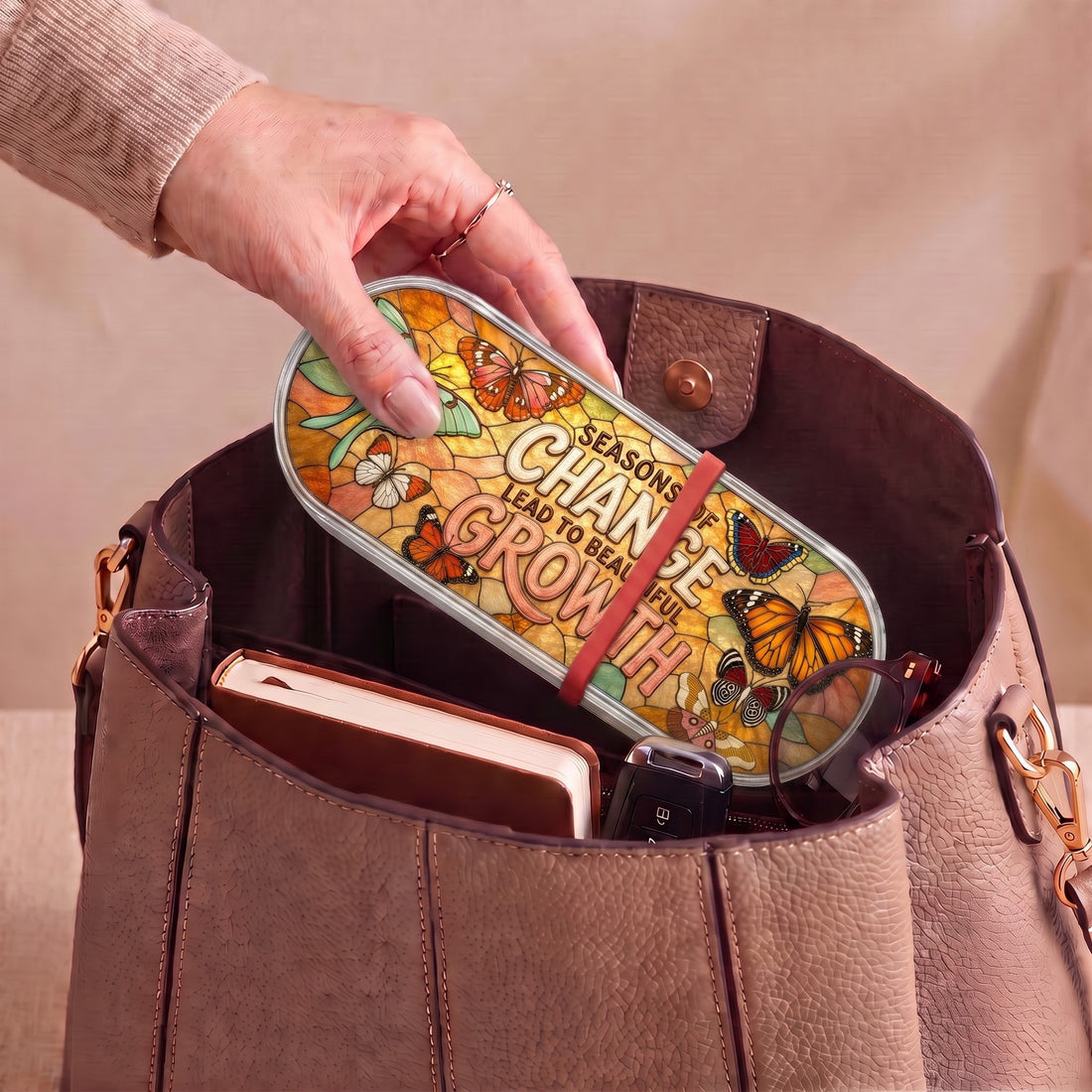 Seasons of Change Lead to Beautiful Growth Pillcase carried inside a handbag with everyday essentials
