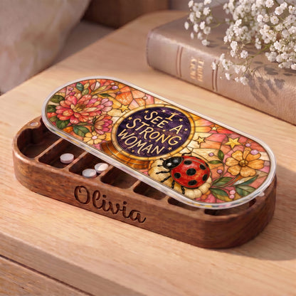 "I See a Strong Woman — Ladybug & Floral Stained Glass" Pill Case — personalized open I See a Strong Woman Pill Case on a wooden table