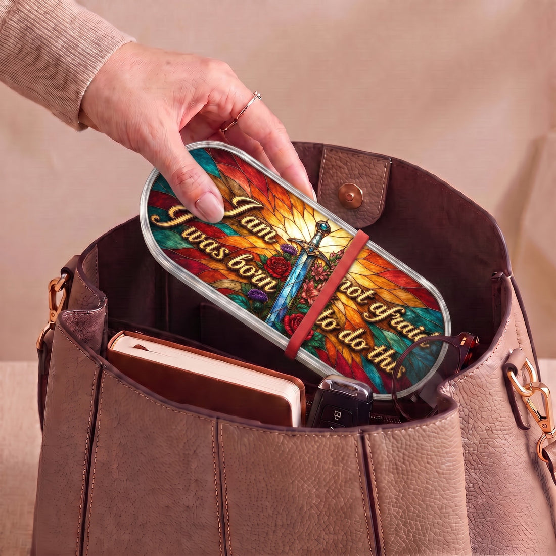 I Am Not Afraid, I Was Born to Do This Pillcase carried inside a handbag with everyday essentials