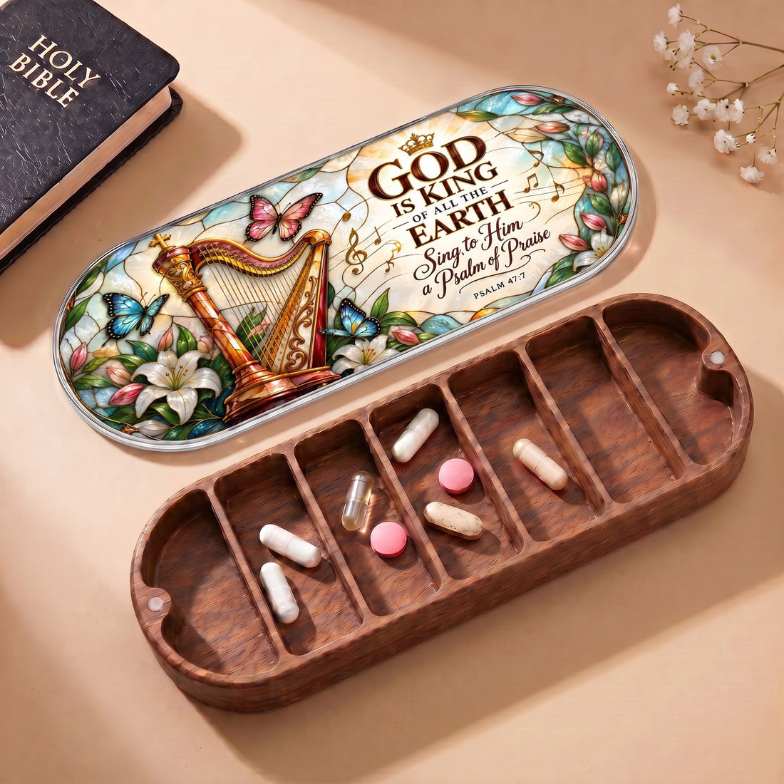 Open wooden Pillcase with God Is King Psalm 47:7 harp and butterfly lid, Holy Bible and daily tablets