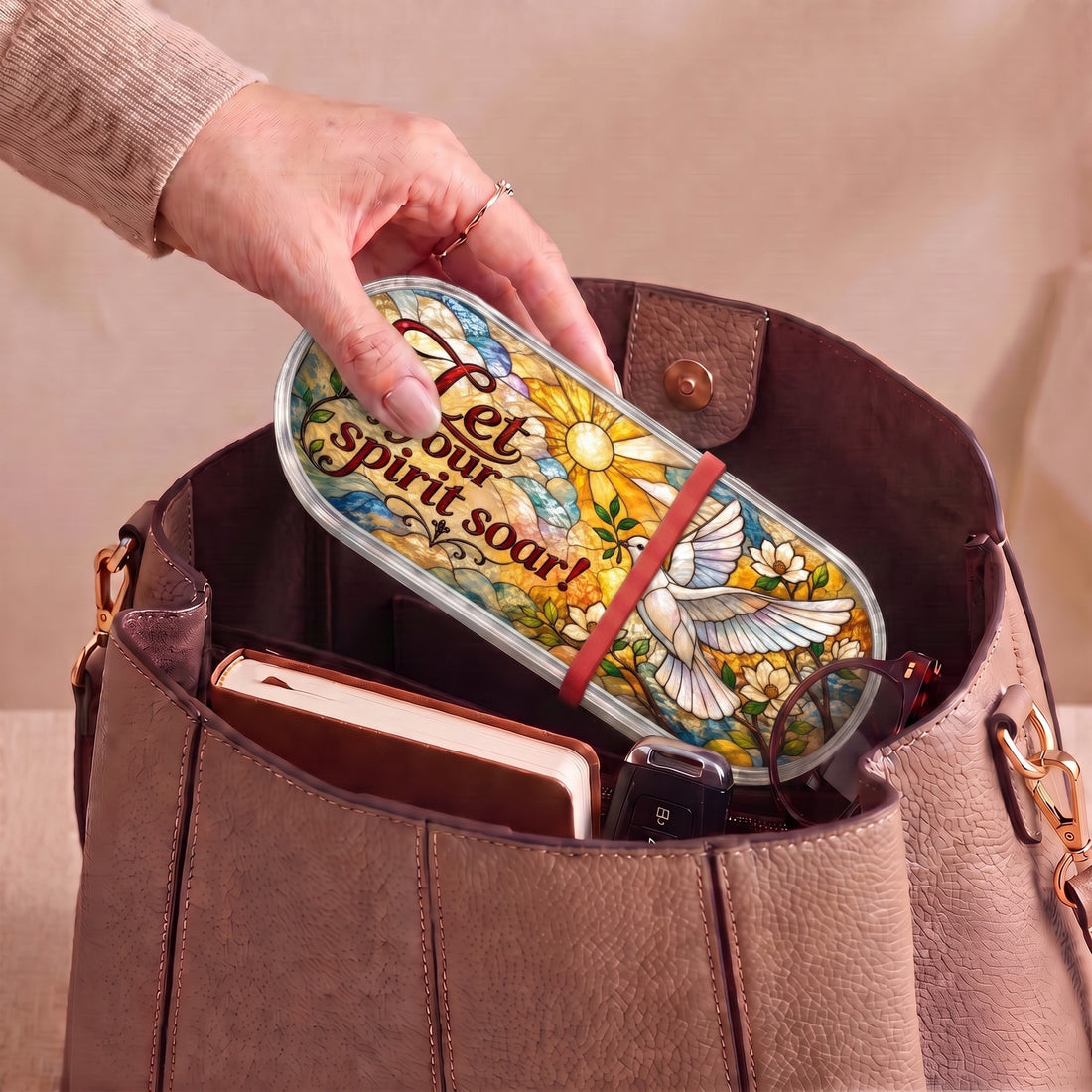 Let Your Spirit Soar dove Pillcase carried inside a handbag with everyday essentials