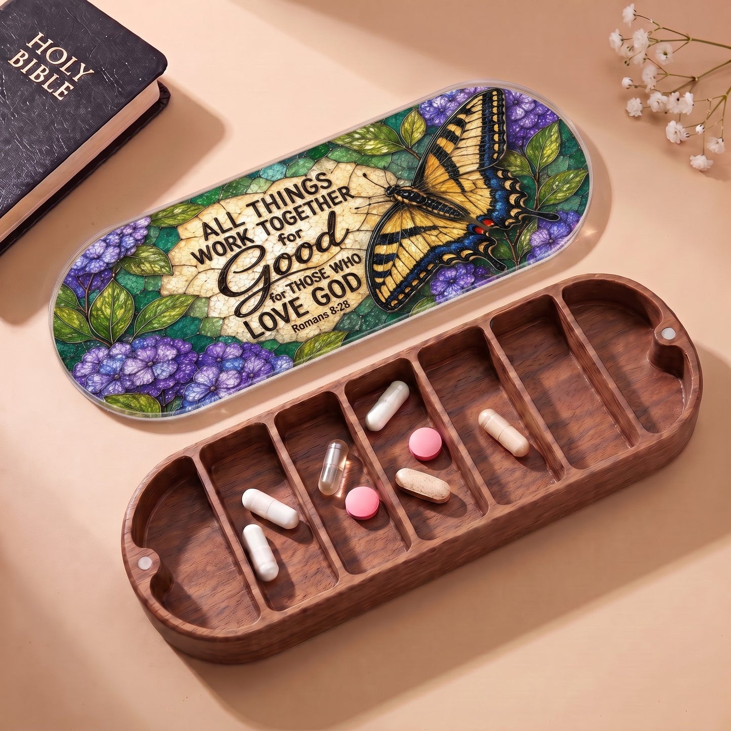 Open wooden Pillcase with Romans 8:28 butterfly floral lid, Holy Bible and daily tablets