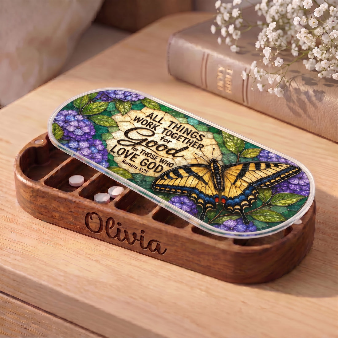 Personalized wooden Pillcase with Romans 8:28 swallowtail butterfly artwork on bedside table