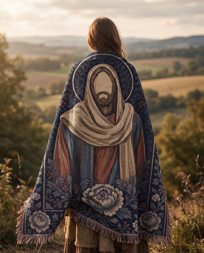 Lifestyle view of Christ icon woven blanket draped over shoulders outdoors