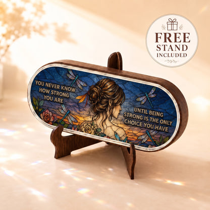You Never Know How Strong You Are Pillcase displayed on included wooden stand