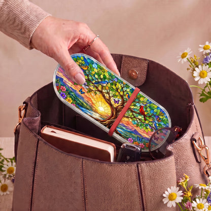 Tree of Life at Sunrise Pillcase carried inside a handbag with everyday essentials and daisies