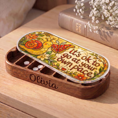 "It’s OK to Go at Your Own Pace — Snail & Butterfly Stained Glass" Pill Case — personalized open snail and butterfly Pill Case on a wooden table