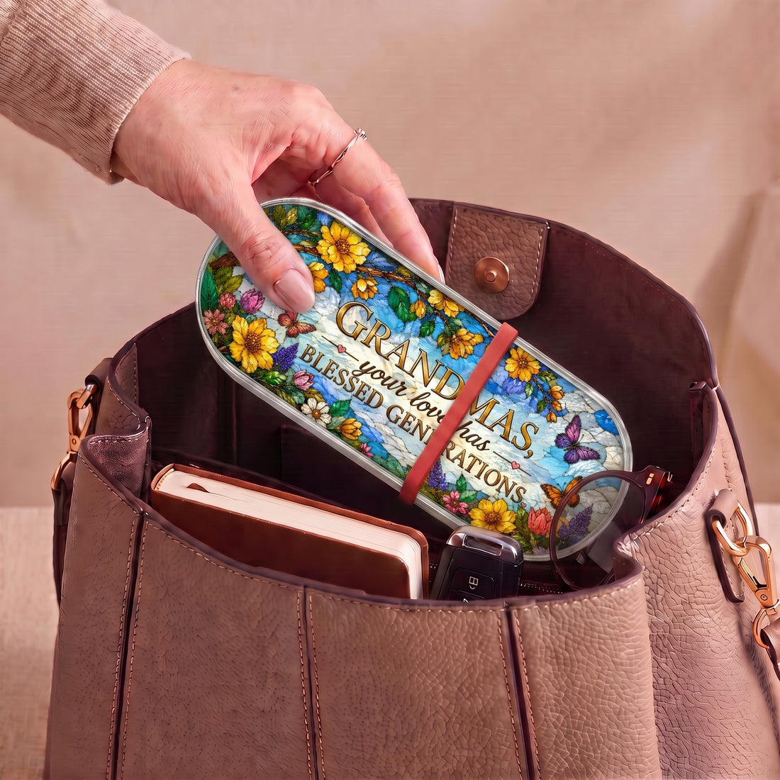 Grandmas Your Love Has Blessed Generations floral Pillcase carried inside a handbag with everyday essentials