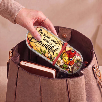 Be Your Own Kind of Beautiful butterfly Pillcase carried inside a handbag with everyday essentials