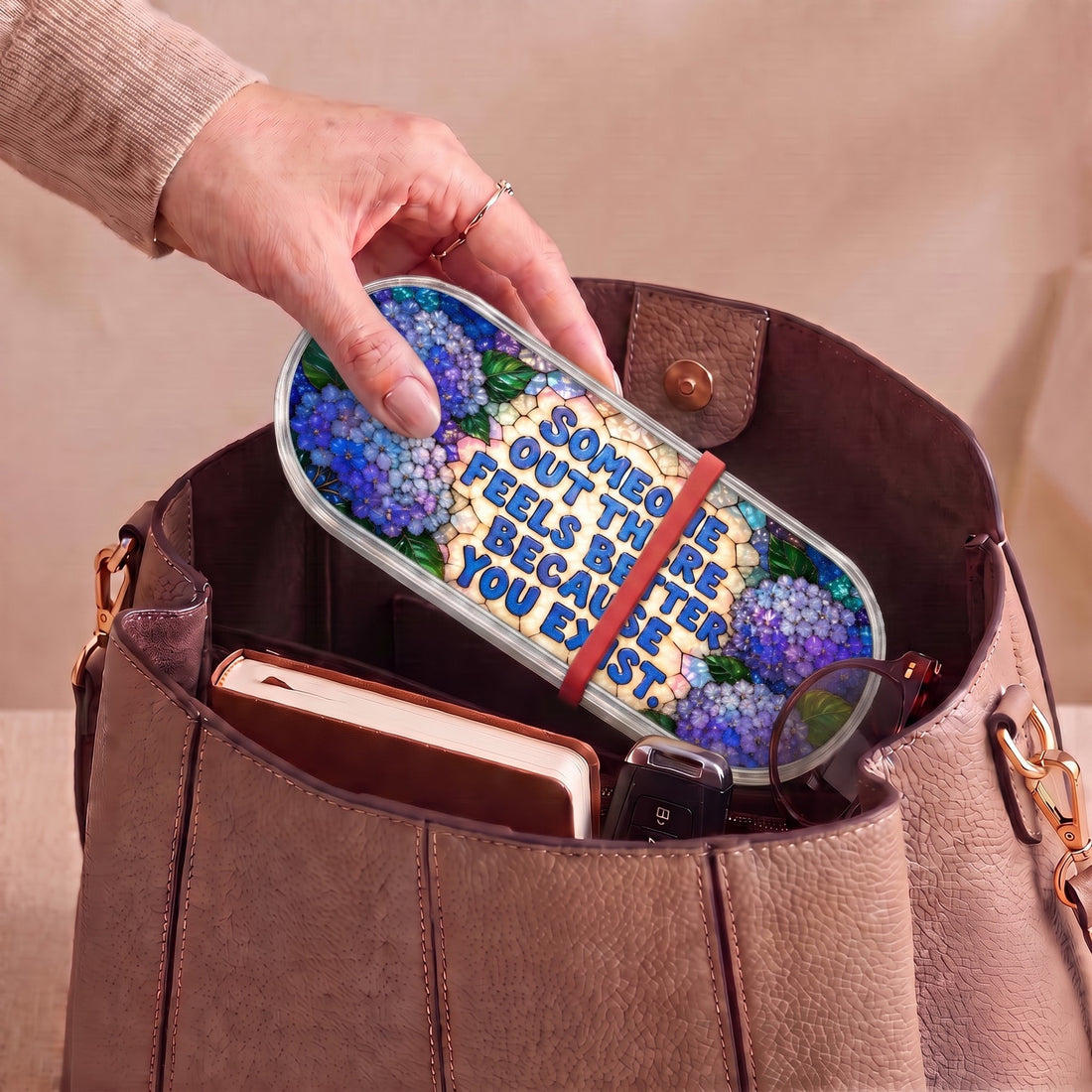 Someone Out There Feels Better Because You Exist blue-hydrangea Pillcase carried inside a handbag with everyday essentials