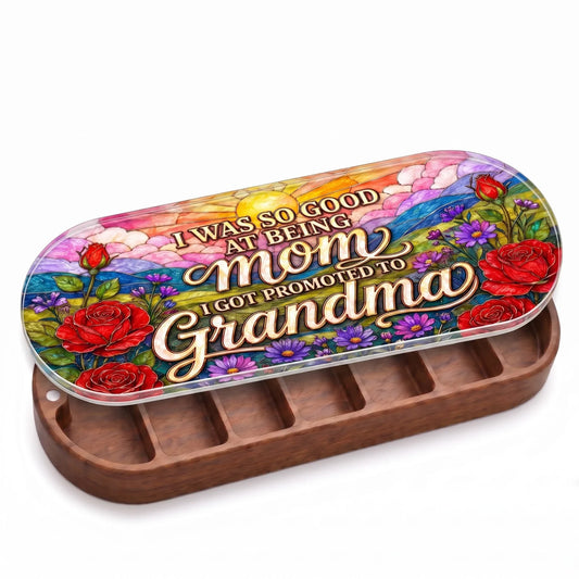 Open wooden Promoted to Grandma Pillcase with red roses and purple flowers on a colorful stained-glass-style lid